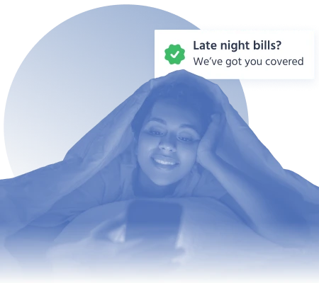 Smiling woman under blanket looking at phone with a notification about late night bill coverage