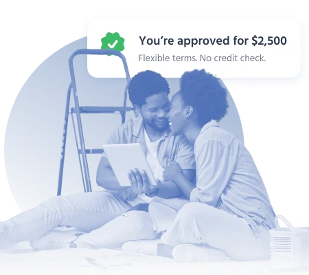 Couple smiling at tablet after $2,500 loan approval with no credit check